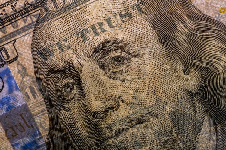 Backlit portrait of Benjamin Franklin from the $ 100 bill with WE TRUST visible in the light