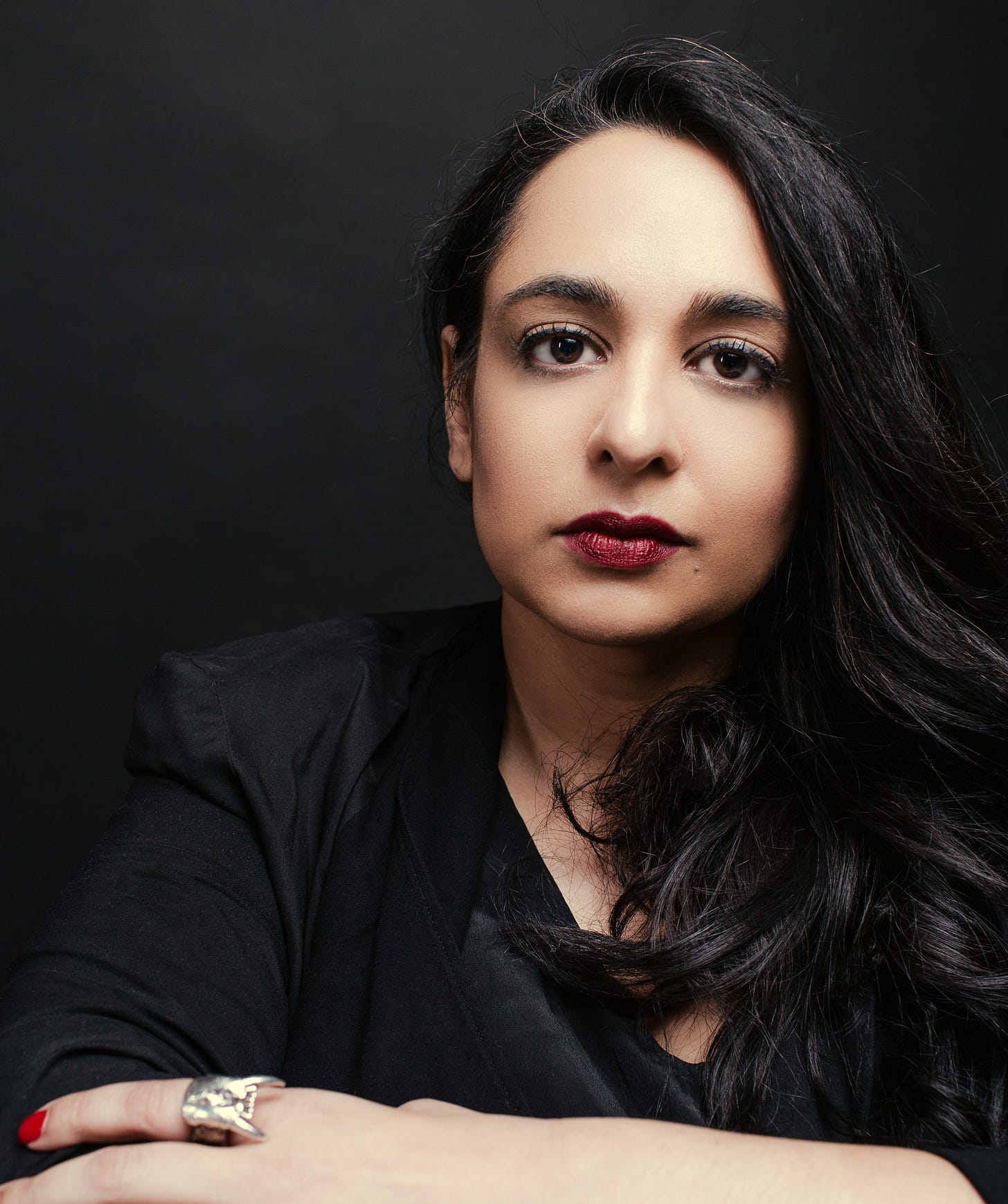 Amina Akhtar wearing black headshot