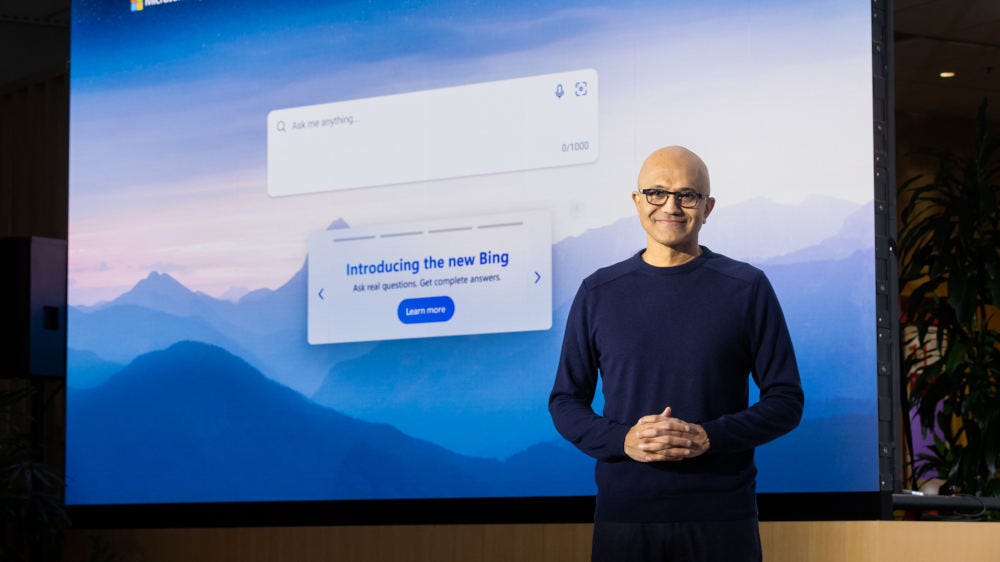 Microsoft CEO Satya Nadella standing in front of a large screen showing the Bing AI chatbot Microsoft CEO Satya Nadella standing in front of a large screen showing the Bing AI chatbot