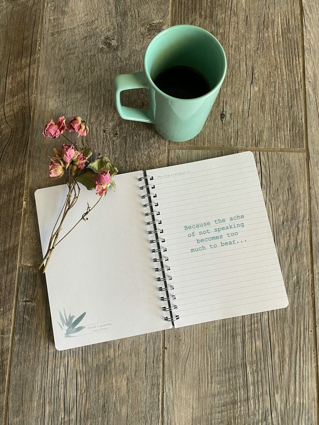 white notebook beside white ceramic mug on brown wooden table white notebook beside white ceramic mug on brown wooden table