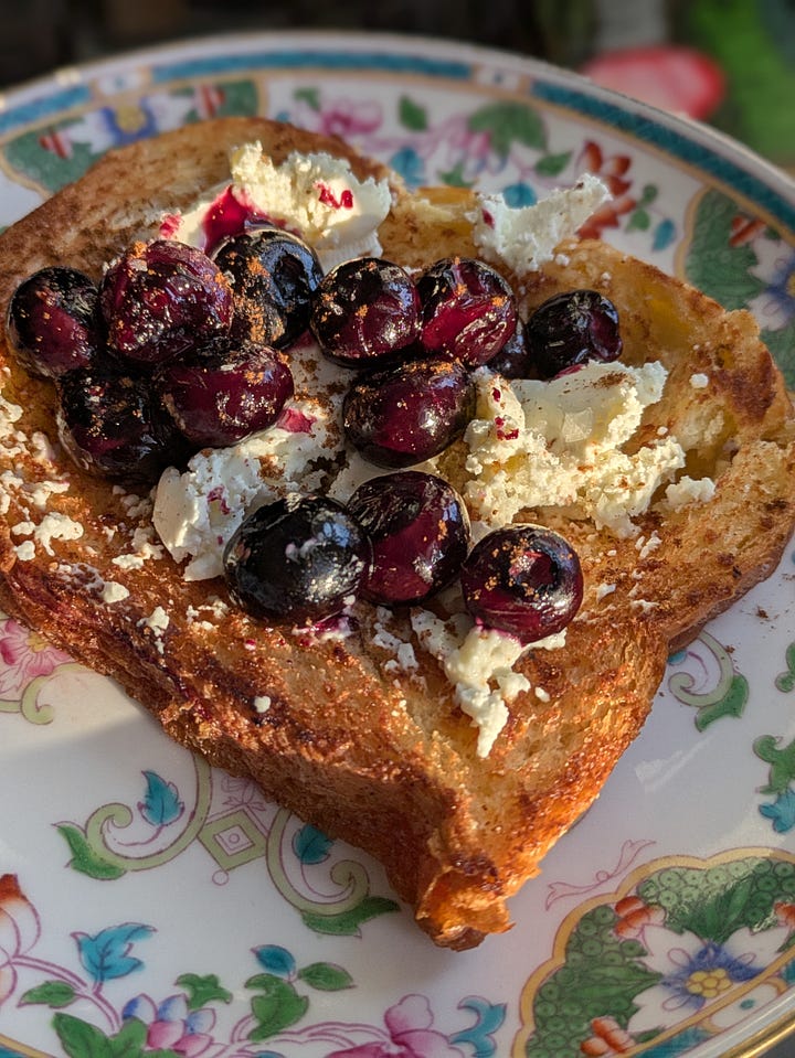 Croissant loaf slice (costco) soaked in butter and toasted in a skillet. With some cinnamon. Crispy slice with blistered blueberries and whipped cream cheese.