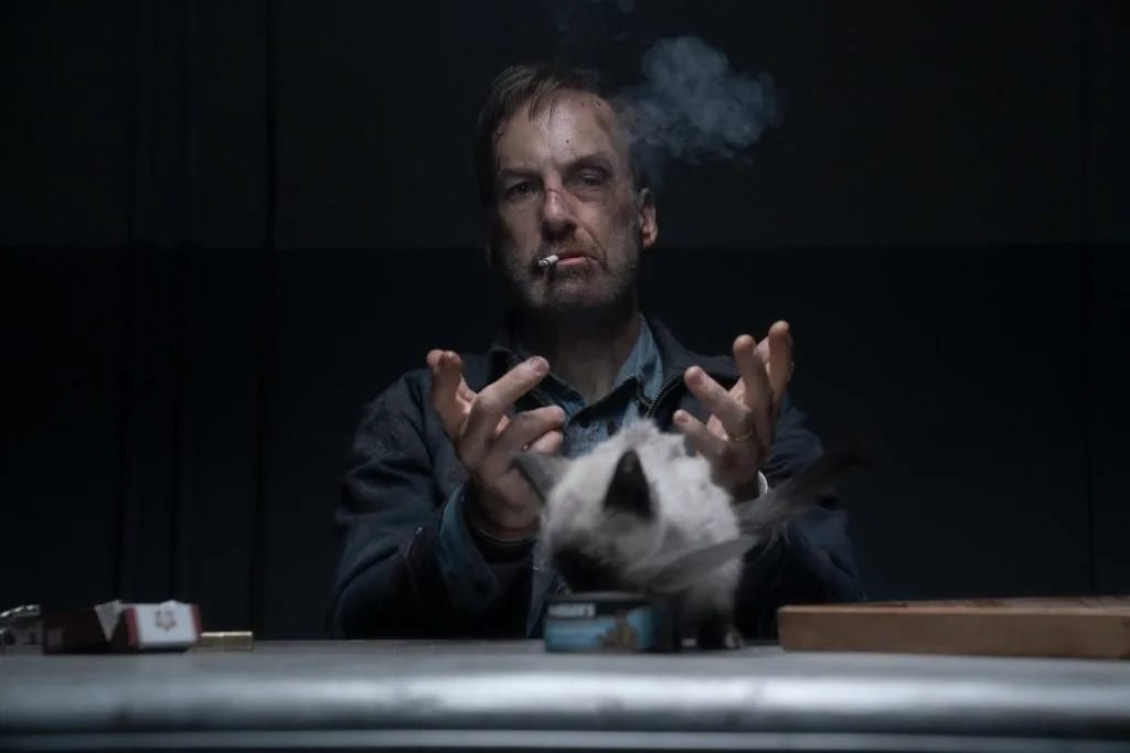 Hutch smoking on a cigarette with a cat. Hutch smoking on a cigarette with a cat.