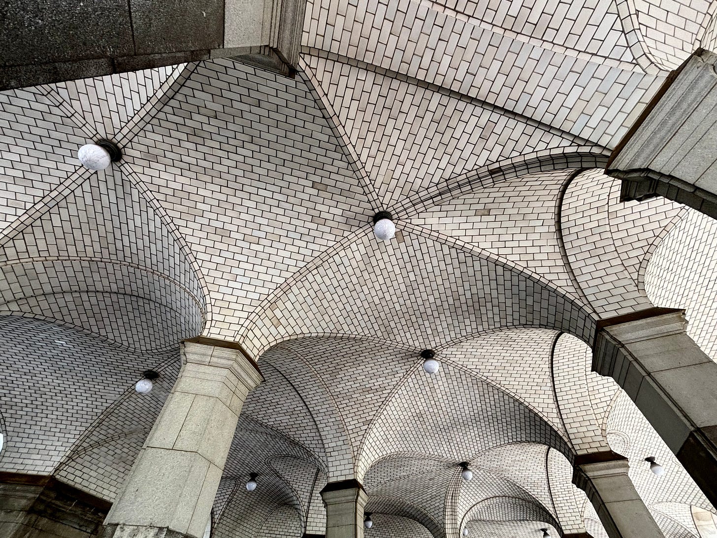 A detail shot of the columns meeting the Guastavino tiled arch.