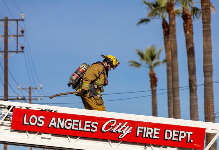 images of firemen working a fire in downtown LA's produce district