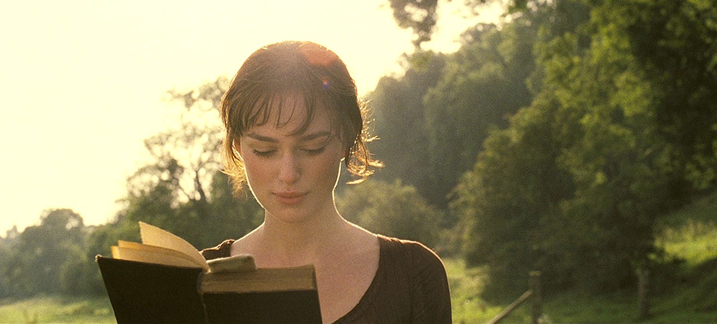 Keira Knightley as Elizabeth Bennet walking while reading a book. 