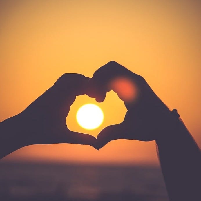 silhouette of person's hands forming heart silhouette of person's hands forming heart
