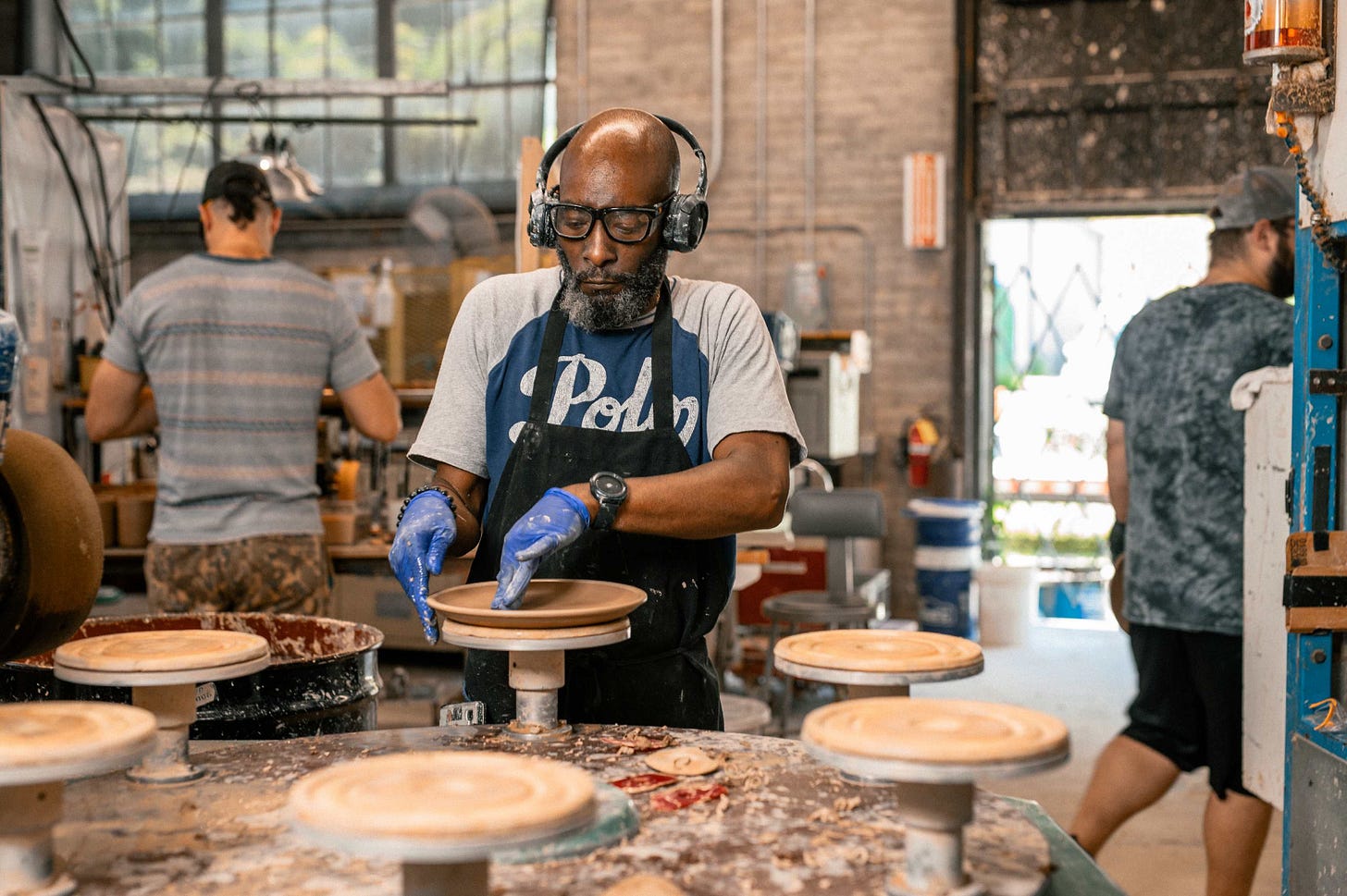 person cleaning rims of bitty bowls by hand