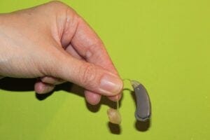 Hand holding a hearing aid