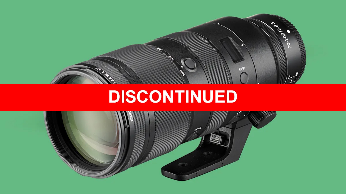 Camera zoom lens – NIKKOR Z 70-200mm f/2.8 VR S – with "DISCONTINUED" text in bold white on a red bar over a green background