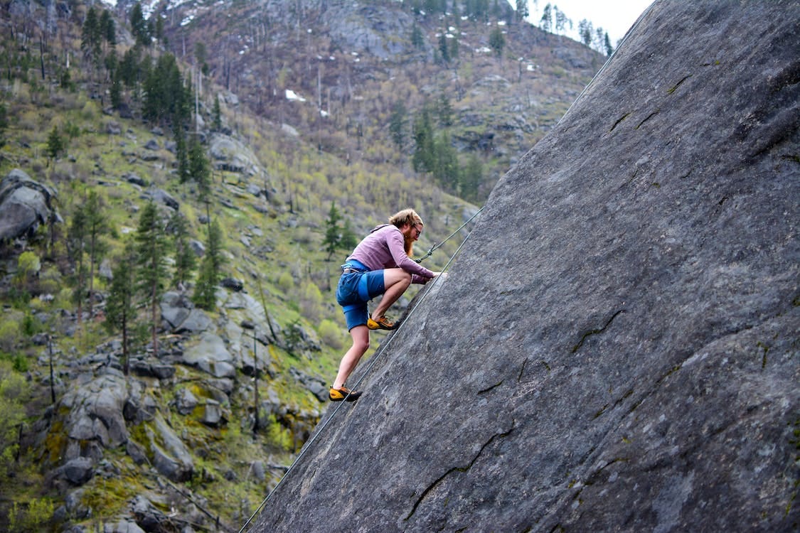 Free Man Climbing on Rock Mountain Stock Photo Free Man Climbing on Rock Mountain Stock Photo