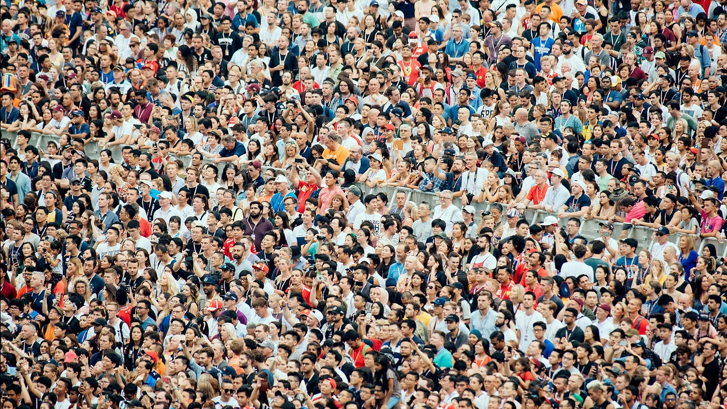 A large crowd of people seated in a stadium
