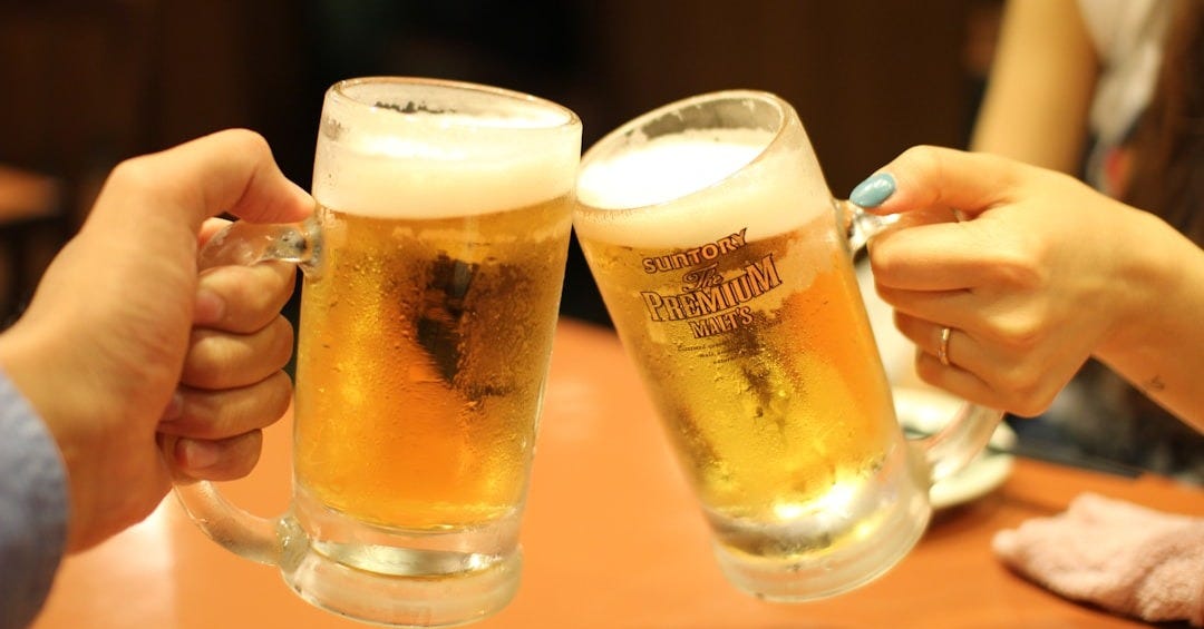 two mugs of brown liquids