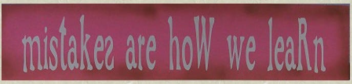 White letters on pink saying "mistakes are how we learn," with several childish errors such as backwards letters and capitals where they do not belong