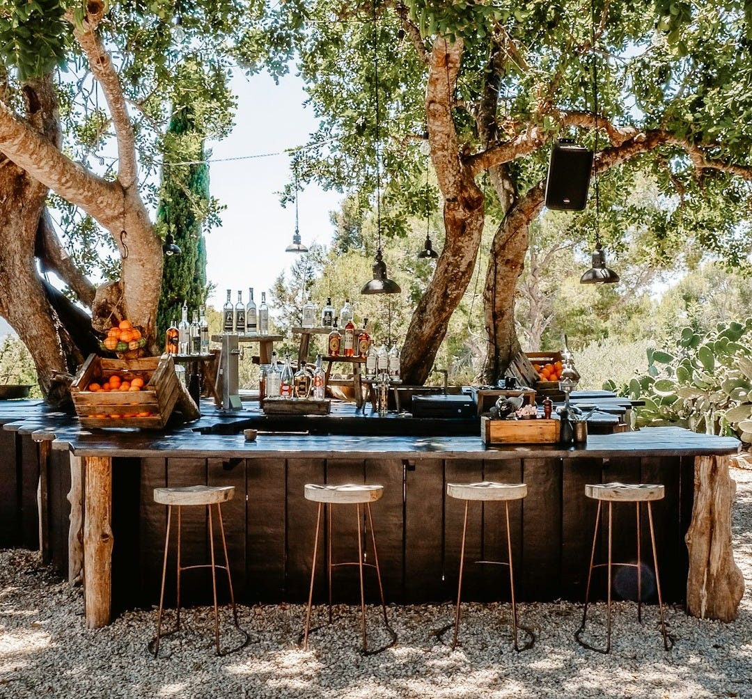 brown wooden table with chairs and trees