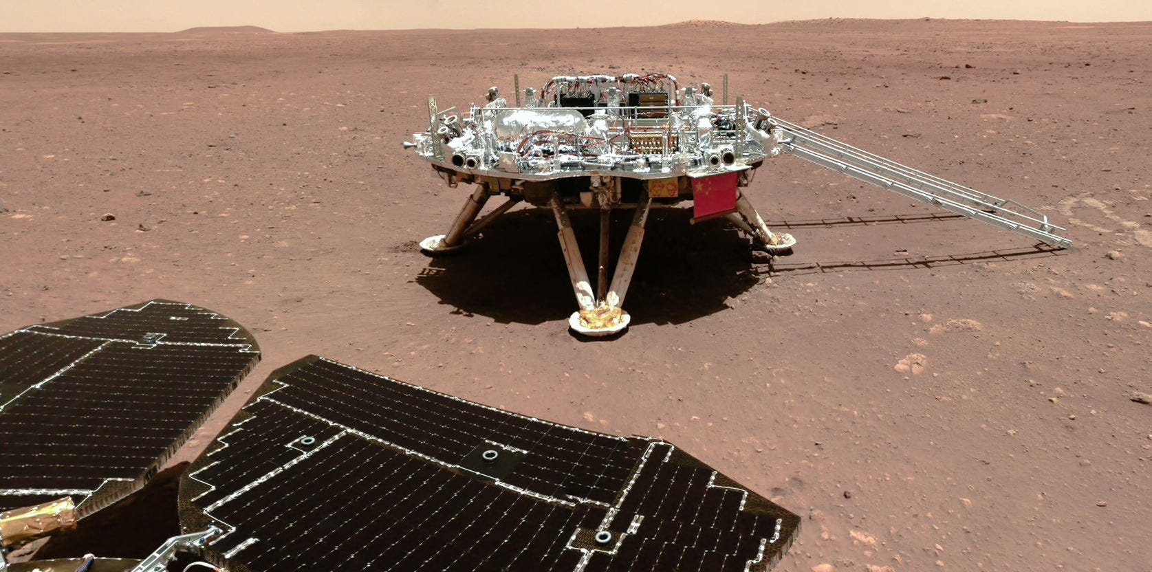 The Tianwen-1 Mars lander as seen by China’s Zhurong rover on the Martian surface. The Tianwen-1 Mars lander as seen by China’s Zhurong rover on the Martian surface.