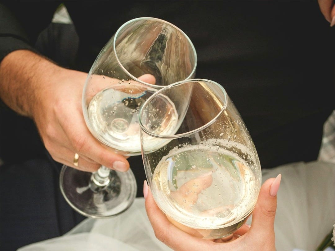 person holding clear drinking glass