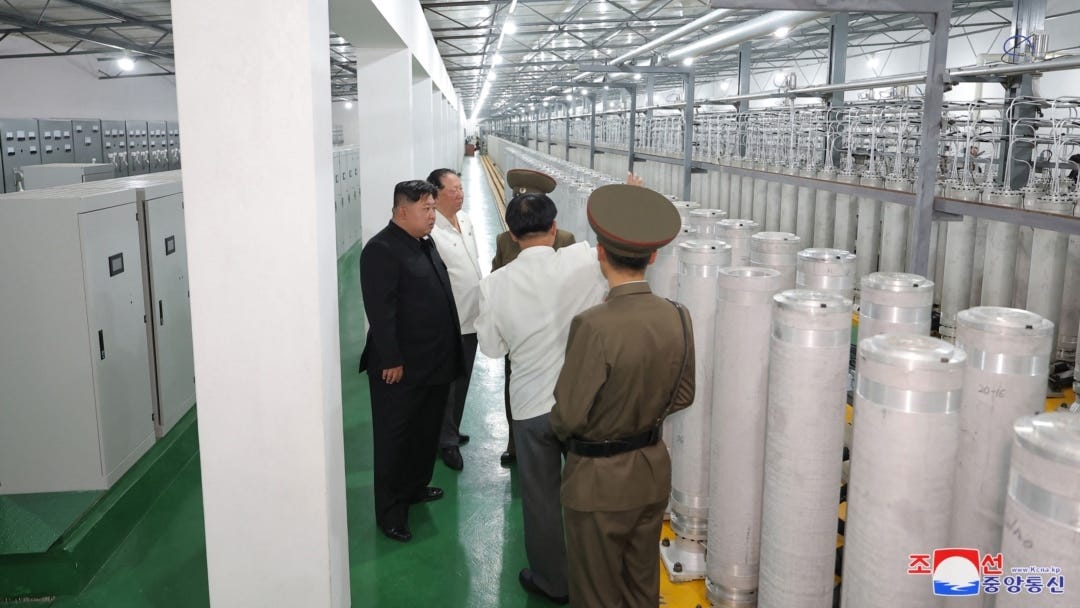 Kim Jong Un and officials walk between rows of centrifuges in a photograph released by North Korean state media.