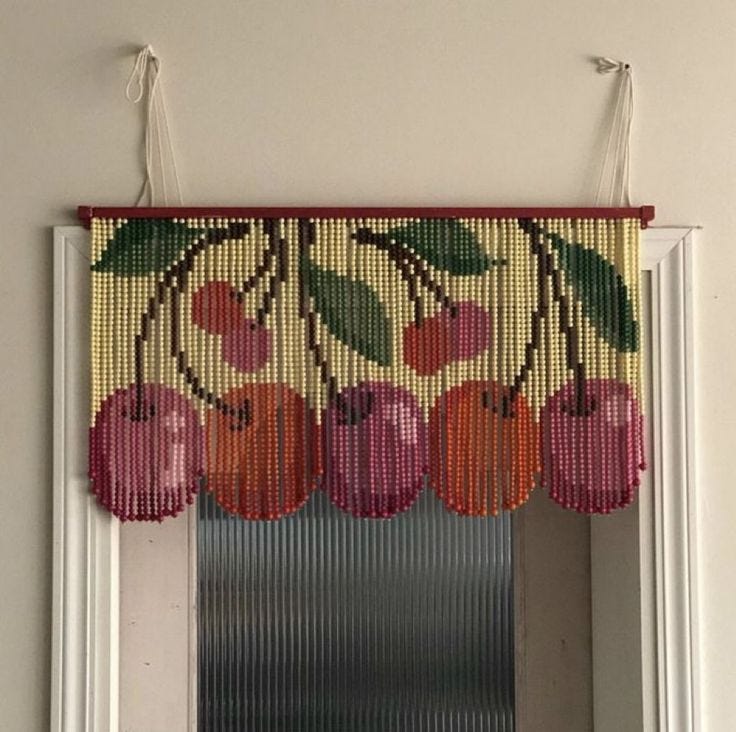 This may contain: a window with beaded fruit hanging from it's side
