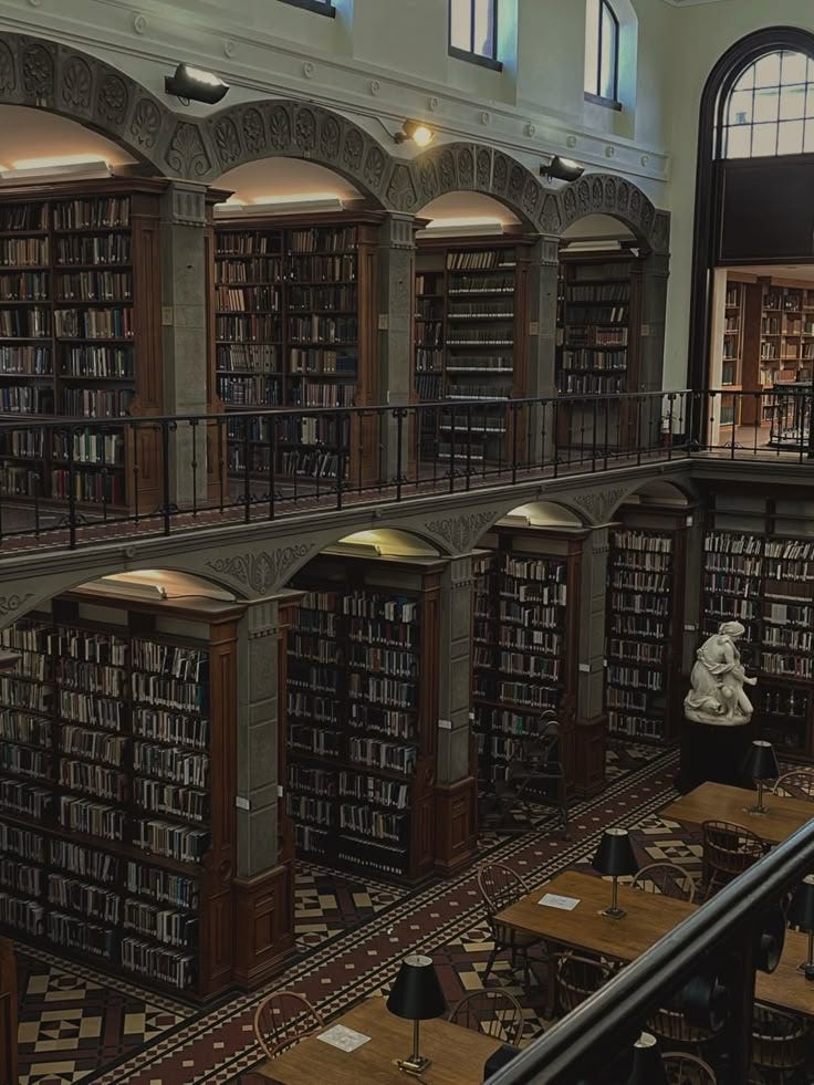 This contains: inside of a two-floor library, nooks of book shelves are built in This contains: inside of a two-floor library, nooks of book shelves are built in