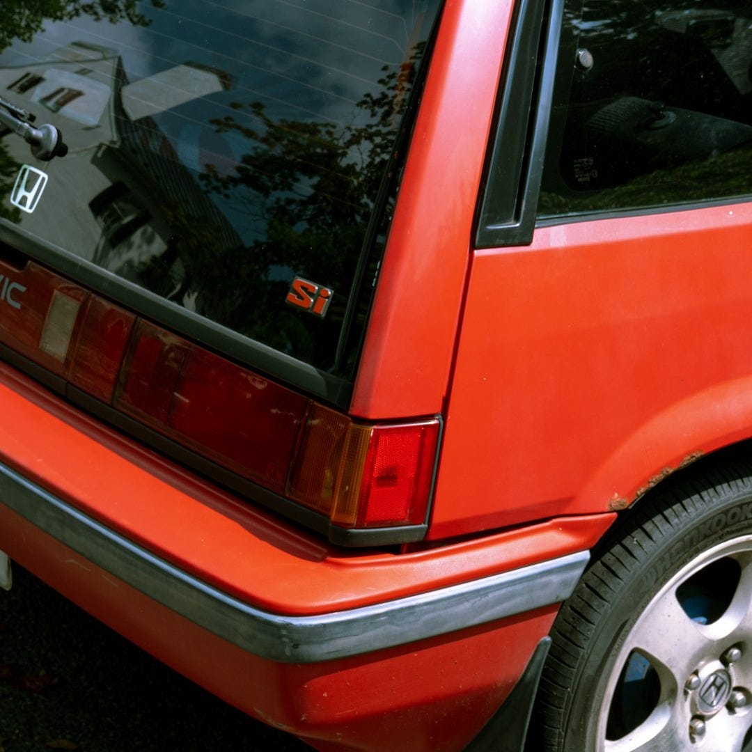 red and black car on road