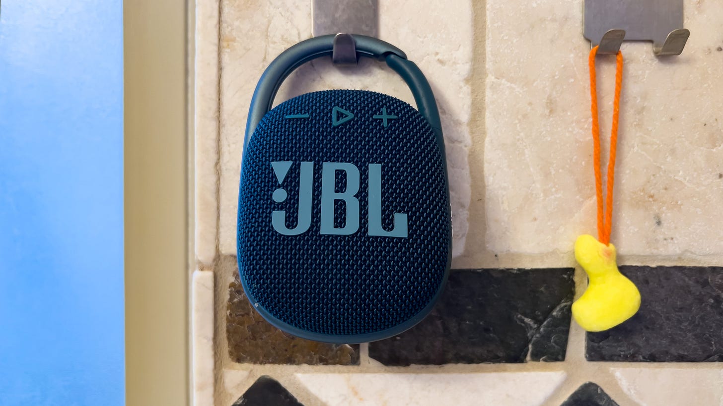 A JBL Clip 4 hangs in a shower next to a duck-shaped soap-on-a-rope A JBL Clip 4 hangs in a shower next to a duck-shaped soap-on-a-rope