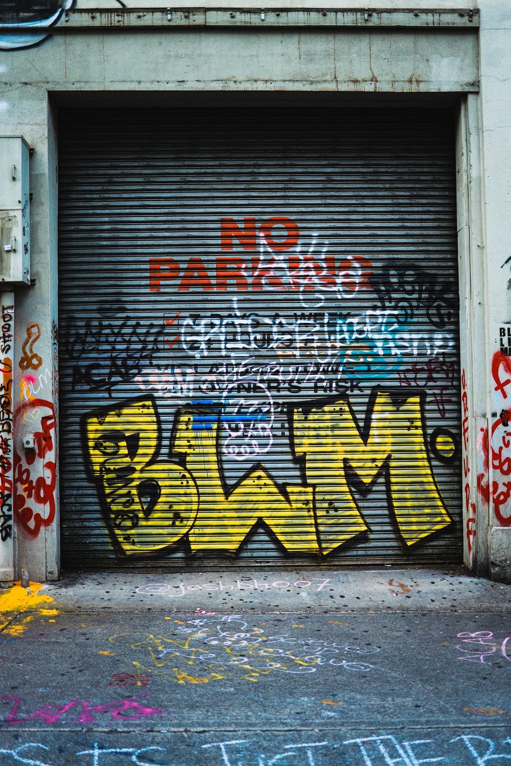 red white and yellow graffiti on gray wall red white and yellow graffiti on gray wall