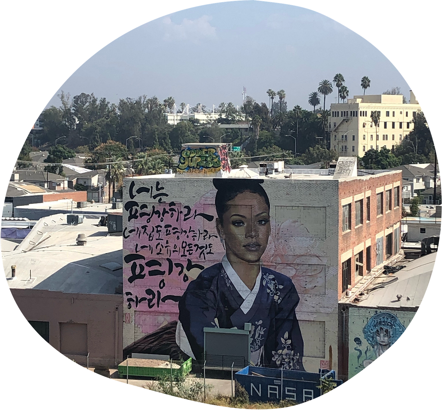 photo of a building in LA, with a huge mural of Rhianna wearing a kimono and some japanese script alongside her