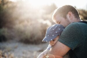 Father hugging infant