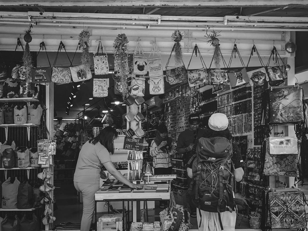 woman in pink top standing beside table