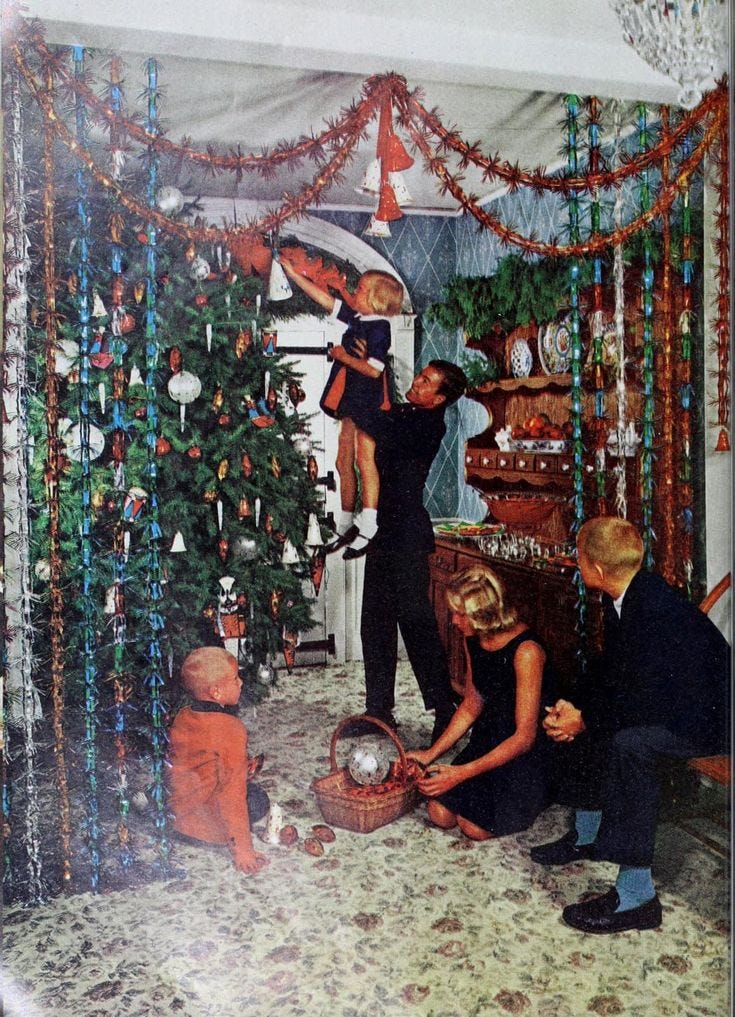 This may contain: a group of people decorating a christmas tree in a living room with ornaments on the walls