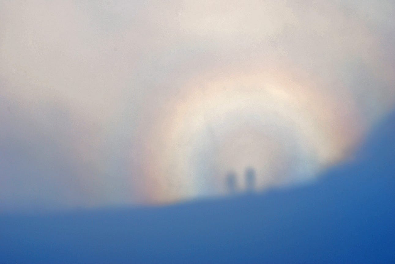 shadows of two people thrown on cloud