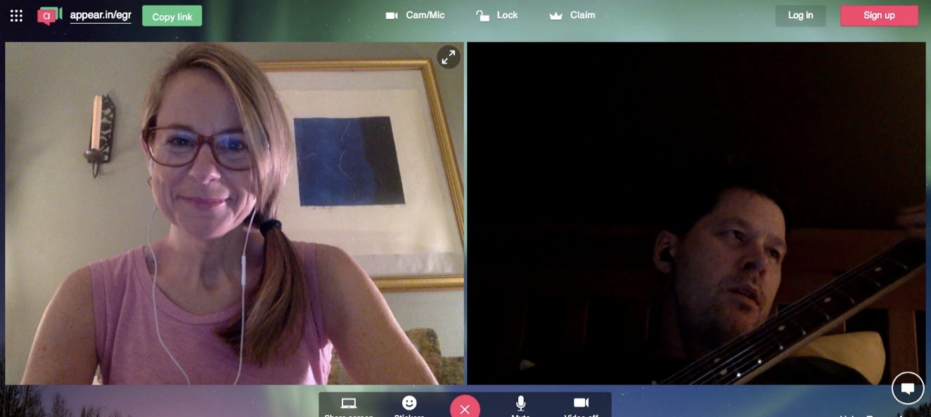 Blonde woman in ponytail and glasses on a FaceTime call with a man playing guitar)
