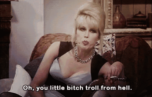 a woman is sitting on a couch smoking a cigarette and saying " oh you little bitch troll from hell " a woman is sitting on a couch smoking a cigarette and saying " oh you little bitch troll from hell "