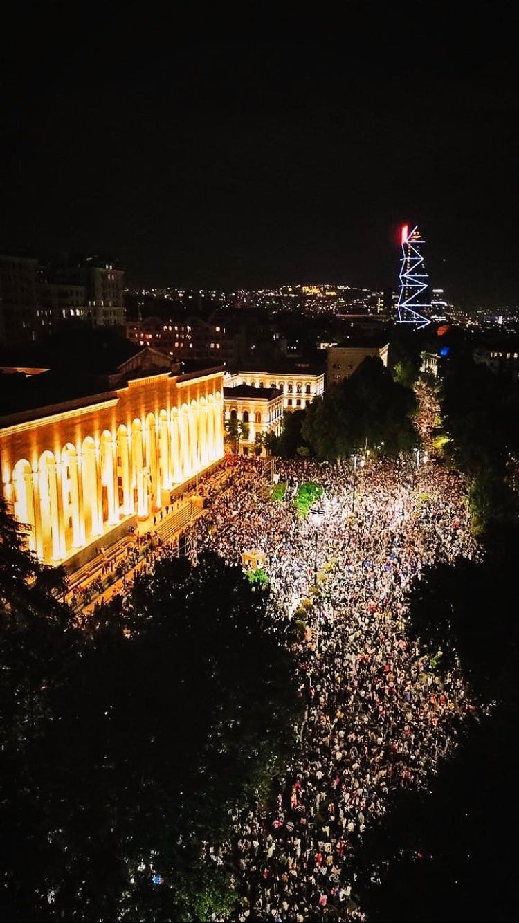 A large crowd of people in a city

Description automatically generated