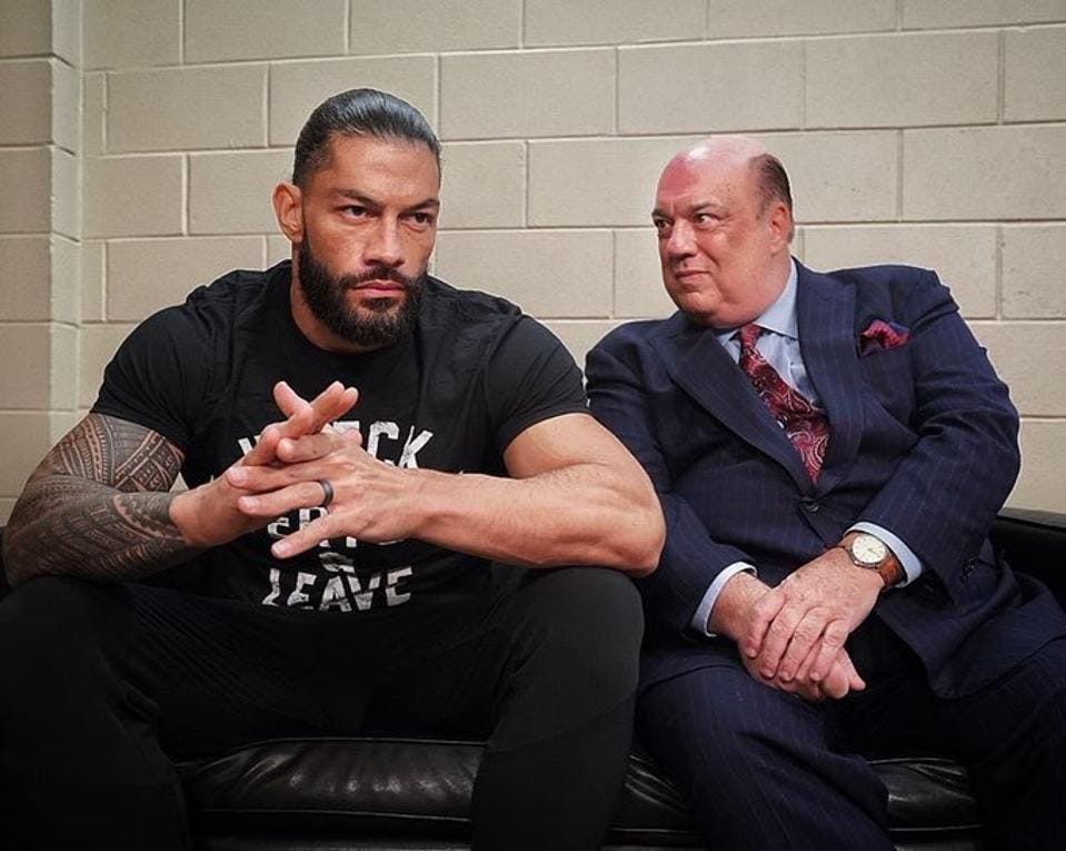 Roman Reigns standing with Paul Heyman in 2020