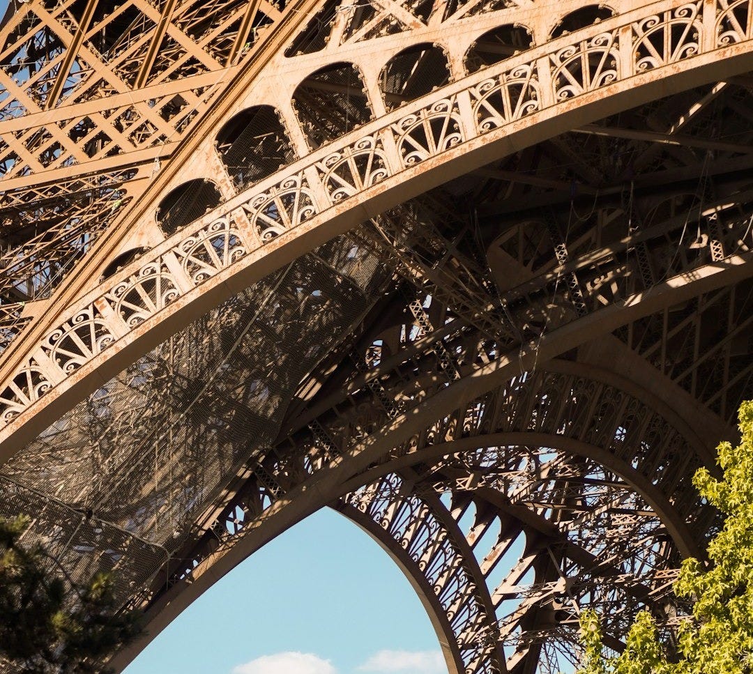 a large metal structure with trees around it a large metal structure with trees around it