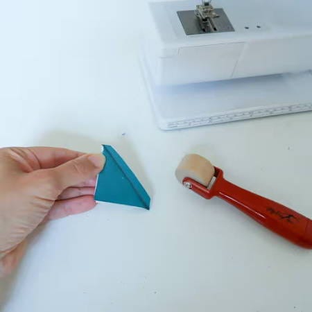 using a seam presser to flatten a seam allowance on a small assembled piece