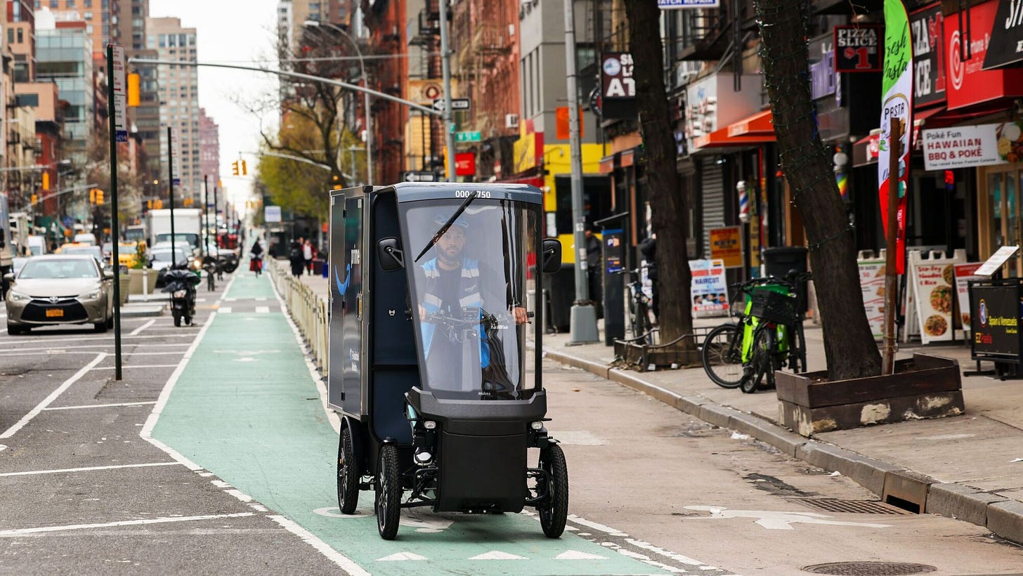 Small enclosed electric vehicle on green bike lane in busy city street
Small enclosed electric vehicle on green bike lane in busy city street