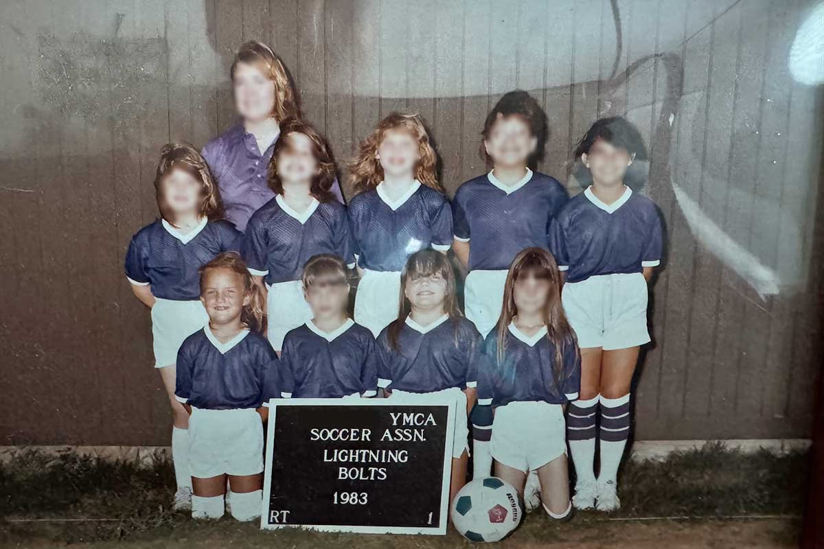 1983 YMCA girls’ soccer team photo with most faces blurred for privacy