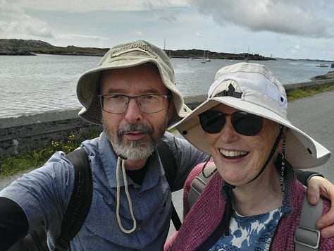 Map of Inishbofin, woman on beach, couple in boat.