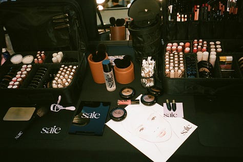 A model at Kallmeyer’s fall 2026 runway show; Saie makeup and a face chart, Saie concealer and bronzer. 