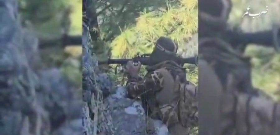 Three sequential frames from a video show a militant in camouflage clothing and headscarf holding a rifle aimed forward from a rocky forested position with trees and bushes in the background Arabic text overlays appear on each frame.