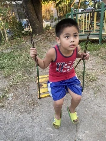 Miguel on the swing in a local park Miguel on the swing in a local park