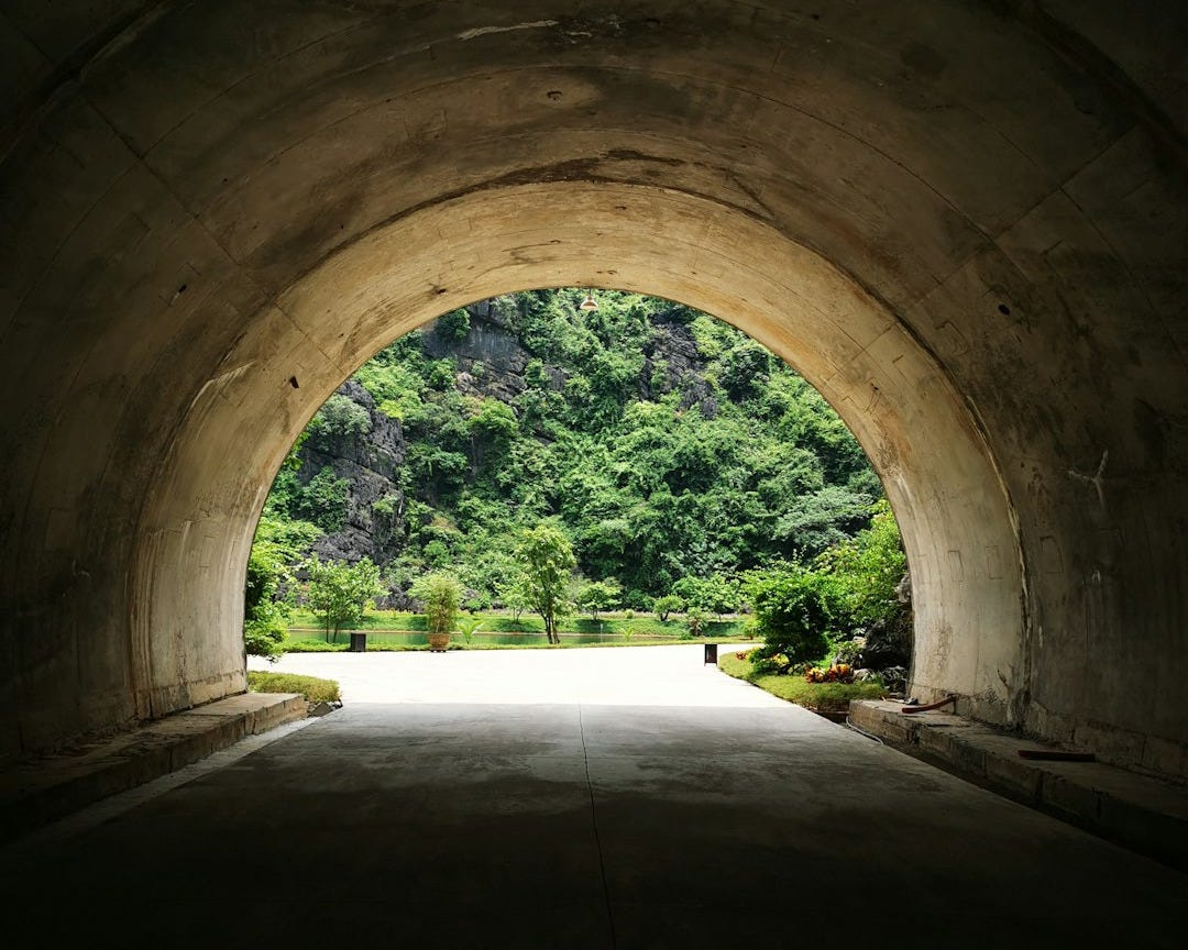 a view of a stone building that has a bridge in the background a view of a stone building that has a bridge in the background