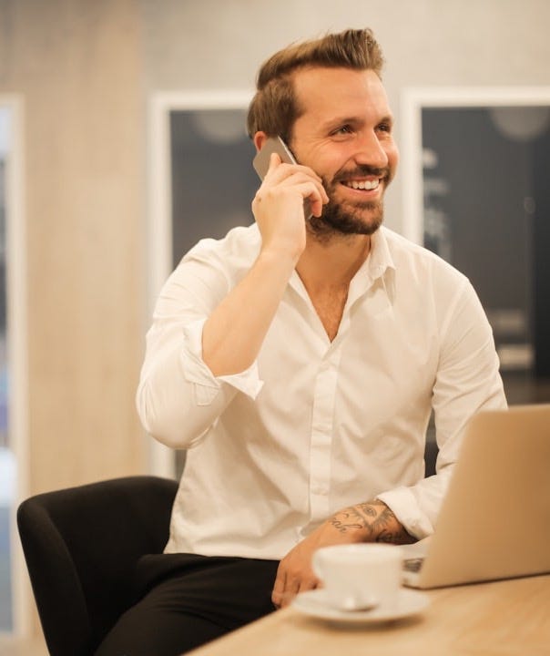 man using smartphone on chair man using smartphone on chair