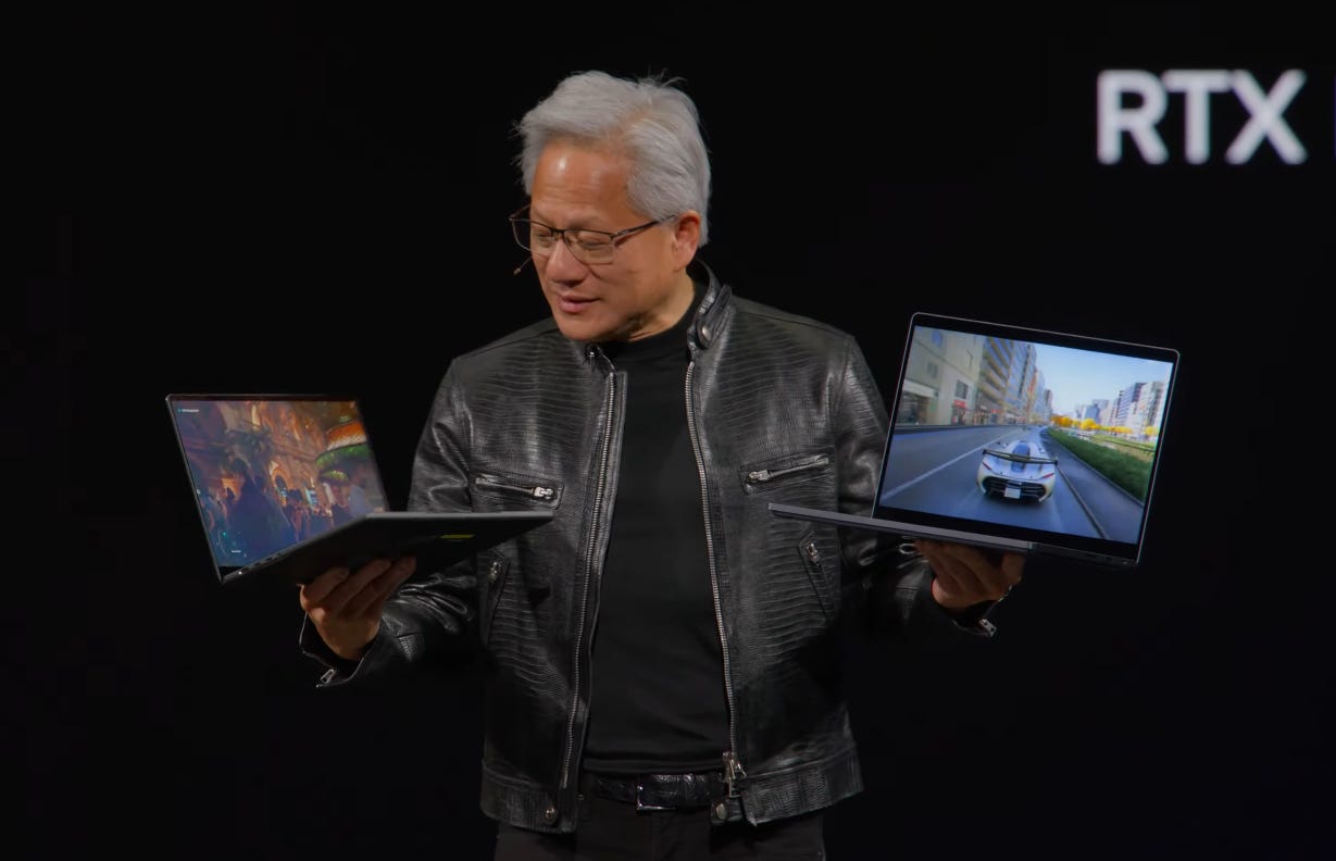 Nvidia’s CEO holds up two RTX Spark laptops at Computex. Nvidia’s CEO holds up two RTX Spark laptops at Computex.