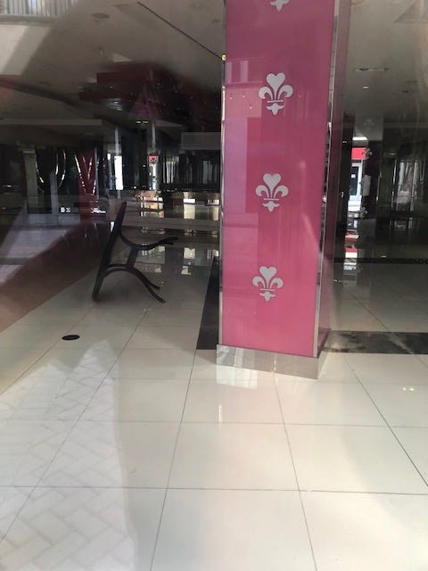 A table is knocked over in a large empty store.