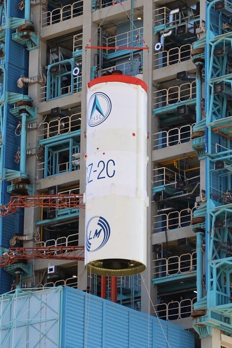 The Long March 2C's second-stage and fairing being placed atop of the launch vehicle.