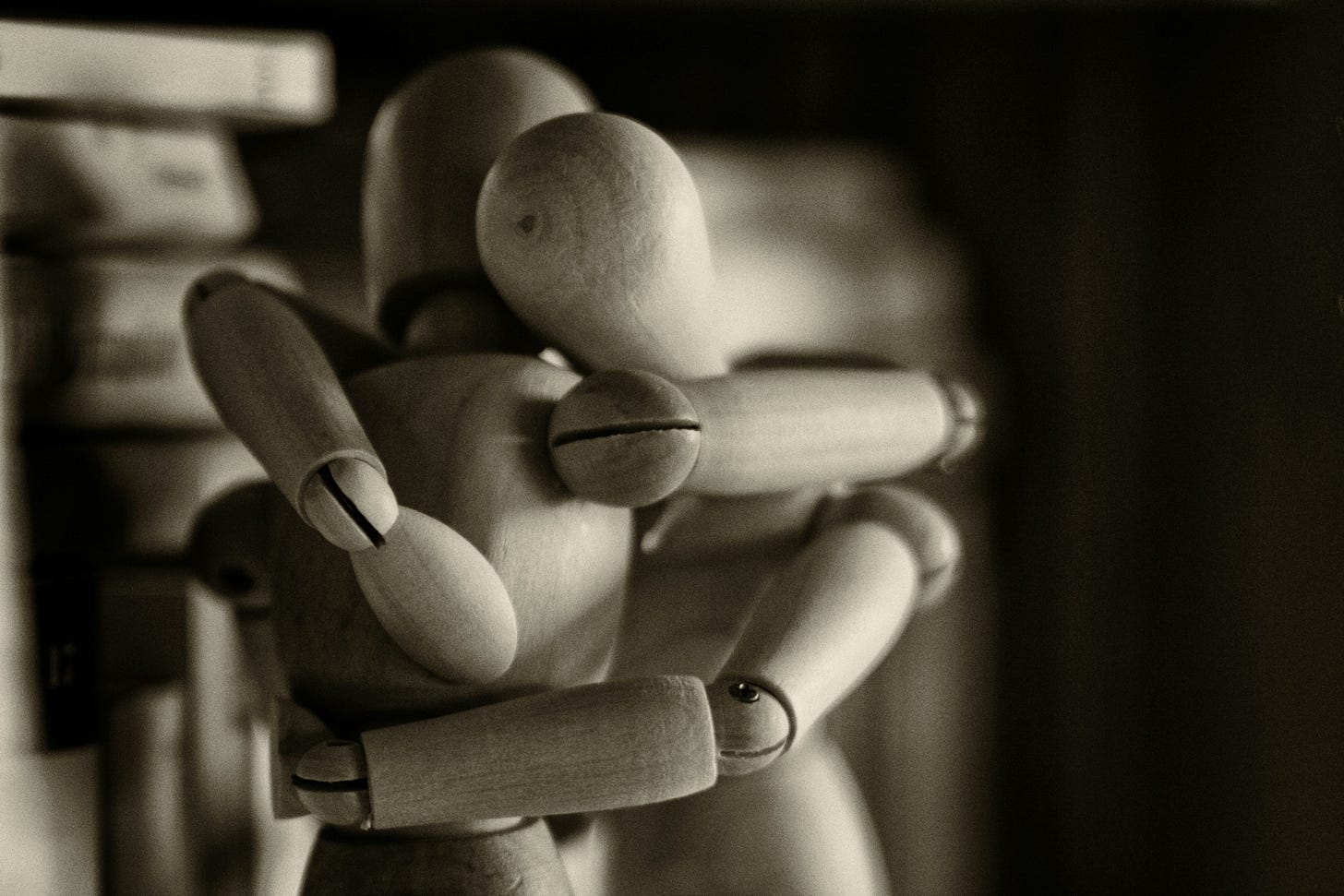 Too wooden models of people hugging.