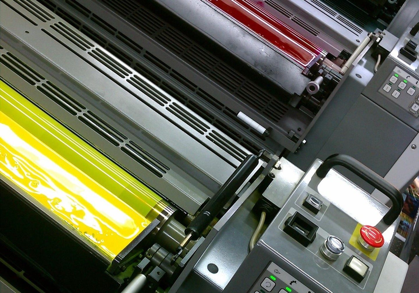 A dye sublimation offset pprinting press. The red and yellow-dye units are in frame.
